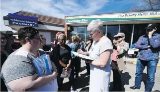  ?? TROY FLEECE ?? Social Services Minister Tina Beaudry-Mellor met with protesters fighting library cuts outside her constituen­cy office in April.
