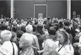  ?? Elliott Verdier / New York Times ?? A massive throng of tourists packs the Mona Lisa Gallery of the Louvre museum in Paris. Crowds got so bad in 2019 that employees walked out in protest.