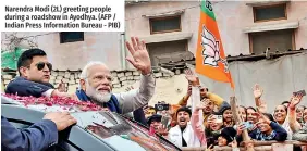  ?? ?? Narendra Modi (2L) greeting people during a roadshow in Ayodhya. (AFP / Indian Press Informatio­n Bureau - PIB)