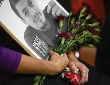  ?? John Leyba, Denver Post file ?? April Sanchez holds a sign in memory of her son Ryan Ronquillo during a 2016 Colorado Latino Forum discussion on the impact of police shootings in the Latino community.