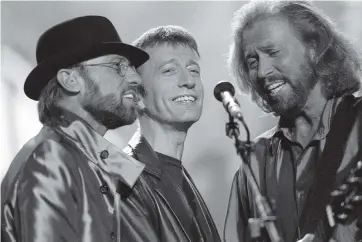  ?? MICHAEL STEPHENS AP ?? File photo dated Sept. 1998 of the Bee Gees, from left, Maurice, Robin and Barry Gibb. Maurice Gibb died at 53 in 2003. His twin Robin Gibb died in 2012 at 62.