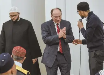  ?? STAFF PHOTO BY FAITH NINIVAGGI ?? SHARED ‘PAIN’: Shaykh Yasir F. Fahmy, left, listens yesterday as Supreme Judicial Court Chief Justice Ralph Gants thanks Executive Director Yusufi Vali for inviting him to the Islamic Society of Boston.