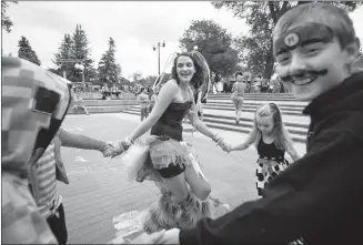  ?? Herald photo by Tijana Martin ?? Lauren Stephanie-Ruth Garrett dances with some of her friend's kids during the fourth annual Lethbridge Electronic Music Festival in Galt Gardens Saturday.