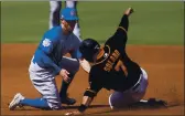  ?? ASHLEY LANDIS — THE ASSOCIATED PRESS ?? The Giants’ Donovan Solano steals second base ahead of Chicago Cubs second baseman Eric Sogard, left, during the first inning of a spring training game Wednesday.