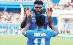  ?? Enyimba midfielder, Chukwuka Onuwa celebrates with a team mate after scoring a goal. ??