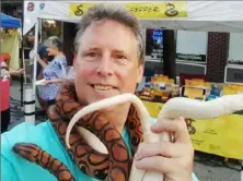  ?? Robert Habegger Facebook ?? Robert "Snakeguy" Habegger with his pet snakes at his booth during a Millvale festival.