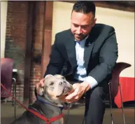  ?? Paul Chinn / The Chronicle ?? Jarrod Wise of the Better Business Bureau pets Sam, a pitbull mix rescued from Hurrican Irma and up for adoption at the Berkeley Humane animal shelter in Berkeley, Calif. on Sept. 26, 2017. A study released by the BBB reports that tens of thousands of consumers have been scammed by fraudulent pet breeders.