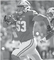  ?? MARK HOFFMAN / MILWAUKEE JOURNAL SENTINEL ?? Wisconsin linebacker T.J. Edwards rumbles 54 yards for a touchdown after intercepti­ng a pass during the first quarter Saturday.