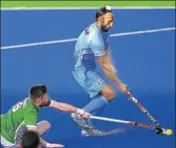  ?? AFP ?? Sardar Singh vies for the ball with Ireland's Shane O'Donoghue.