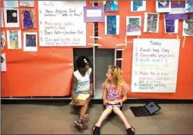  ?? NWA Democrat-Gazette/CHARLIE KAIJO ?? Ankita Nair (from left), 10, and Serenity Crose, 11, discuss a story they are working on during a summer writing camp Thursday at Creekside Middle School in Bentonvill­e. Fifth-graders at Creekside Middle School learned about writing strategies and the writing process in a two-week summer writing camp. The camp was hosted by Creekside Middle School with the University of Arkansas and The National Writing Project. Kim Kendrick and Christin Rupert, literacy teachers at Creekside, created lessons designed with a variety of genres and topics including poetry, narrative stories and play writing.