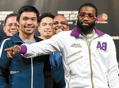  ?? —AFP ?? A calm Manny Pacquiao (left) cools down the heat after his opponent, Adrien Broner, went on a tirade against several people during their press conference.