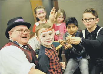  ??  ?? Youngsters are entertaine­d at the Rainbow Trust’s Christmas Party by magician Iain Jay.