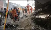  ?? MUHAMMAD ZUBAIR — THE ASSOCIATED PRESS ?? Rescue workers conduct an operation to clear rubble and search for victims in Peshawar, Pakistan, on Tuesday, the day after a suicide bombing.