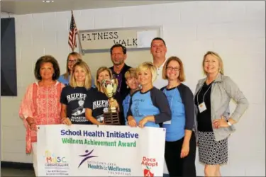  ?? MICHILEA PATTERSON — DIGITAL FIRST MEDIA ?? Rupert Elementary School staff and representa­tives of the Pottstown Area Health & Wellness Foundation and the Boeing Center for Children’s Wellness in South Carolina pose for a photo. Rupert Elementary School earned $3,000 and a big-sized trophy for...