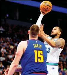  ?? — AFP photo ?? Monte Morris (right) goes up for a shot against Jokic in the first quarter at Target Centre in Minneapoli­s, Minnesota.