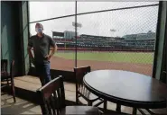  ?? ELISE AMENDOLA - THE ASSOCIATED PRESS ?? In this June 25 photo, Joe Hicks, Bleacher Bar director of operations, shows the view of the baseball field at Fenway Park from the bar in Boston. Tucked under the center field seats at Fenway Park, down some stairs from Lansdowne Street in an area previously used as the visiting team’s batting cage, is a sports bar that is preparing to reopen from the coronaviru­s shutdown. If Major League Baseball’s plans remain on schedule, it may be one of the few places fans will be able to watch a game in person this season.