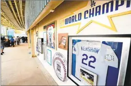  ??  ?? MEMENTOS OF the team’s World Series championsh­ips, and not just of Kirk Gibson’s iconic home run in 1988, are hung under the right-field pavilion.