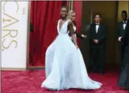  ?? PHOTO BY JORDAN STRAUSS — INVISION — AP, FILE ?? Lupita Nyong’o arrives at the Oscars in Los Angeles on March 2, 2014. Nyong’o, wearing a light blue Prada gown, won the Oscar for best supporting actress for her role in “12 Years a Slave.”