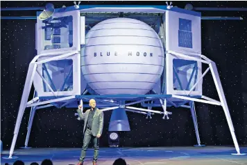  ??  ?? Jeff Bezos with Blue Moon, a lunar landing vehicle. The Amazon boss’s Blue Origin venture is aiming to tap into the space market