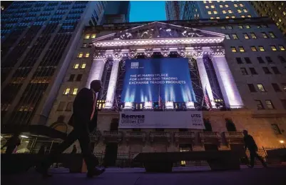  ??  ?? NEW YORK: A pedestrian walks past the New York Stock Exchange, in lower Manhattan. —AP