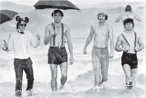  ?? PHOTO: OTAGO DAILY TIMES FILES ?? Thousands of people gathered on St Clair Beach to see nearly 1000 take to the chilly waters of the Pacific Ocean in June 1978 in the annual Polar Plunge. Dressed for the occasion were four students (from left) Gerry Hennessy, Nigel Murray, Ray Bruce...