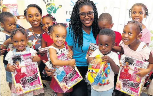  ??  ?? Monique Murdock (second left), teller, and Talishia Byfield, client service representa­tive of Sagicor Bank, May Pen, share a moment with little ones from Prime Time Early Childhood Institutio­n in May Pen, Clarendon, on December 11, after presenting them with gifts at the Sagicor Foundation Adopt-ASchool Christmas treat.