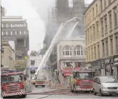  ?? — AFP ?? Firefighte­rs work at the scene of a fire at the Glasgow School of Art.