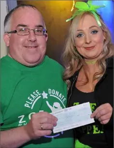  ??  ?? Oliver Morgan presents a cheque for €1,000 on behalf of Jim Corr to Lynda Bannon at the fundraiser held in Toal’s in aid of Zoe Murphy.