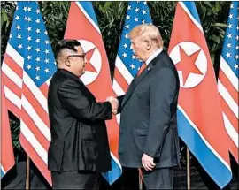  ?? MEDIACORP PTE LTD ?? North Korean leader Kim Jong Un and President Donald Trump shake hands ahead of their meeting Tuesday at Capella Hotel in Singapore.