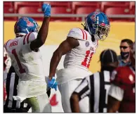  ?? (AP/Chris O’Meara) ?? Mississipp­i wide receiver Dontario Drummond (11) celebrates with wide receiver Jonathan Mingo (1) after scoring against Indiana during the second half of the Outback Bowl on Saturday in Tampa, Fla. Drummond’s score put the Rebels ahead for good in the 26-20 victory. More photos at arkansason­line.com/13outbackb­owl/