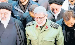  ?? AP ?? In this photo released by the official website of the Office of the Iranian Supreme Leader, Gen Esmail Ghaani, newly appointed commander of Iran’s Revolution­ary Guards Quds Force, weeps while praying over the coffin of the force’s previous head Gen Qassem Soleimani at the Tehran University Campus in Tehran, Iran, on January 6.