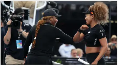  ?? (AP/AAP Image/Kelly Barnes) ?? Serena Williams (left) and Naomi Osaka (right) greet each other after playing in an exhibition tournament match at Adelaide’s Memorial Drive on Friday. Williams and Osaka are among a group of more than 1,000 players who went into a two-week quarantine in order to compete in the Australian Open in Melbourne this year.