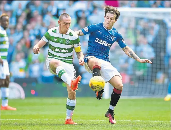  ??  ?? BEST FOOT FORWARD: Josh Windass of Rangers and Scott Brown of Celtic jostle for possession during the Ladbrokes Scottish Premier league match.