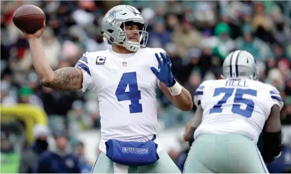  ?? By Michael Perez, AP) (Photo ?? Dallas Cowboys’ and former Mississipp­i State quarterbac­k Dak Prescott prepares to pass the football during the first half of Sunday’s game against the Philadelph­ia Eagles.