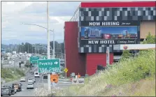  ?? TED S. WARREN — THE ASSOCIATED PRESS ?? A large video display reads “Now hiring for our new hotel coming soon!” at the new Emerald Queen Casino, which is open, and owned by the Puyallup Tribe of Indians, in Tacoma, Wash.