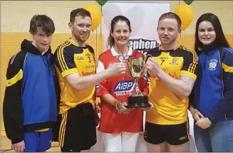  ??  ?? Adam, Orla and Amy Melia present the Stephen Melia 7s trophy to Ramor United players.