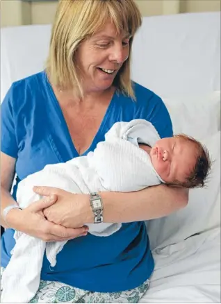  ?? Photo: DEAN KOZANIC/FAIRFAX NZ ?? Tworeasons to celebrate: Nicola Rich cradles 10-hour-old son Connor, born at 12.04am on Christmas Day at Christchur­ch Women’s Hospital.