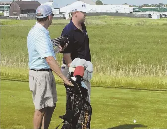  ?? AP PHOTO ?? FAMILY MATTER: Davis Love IV (right) consults with his caddie, dad Davis Love III, during a U.S. Open practice round at Erin Hills yesterday in Erin, Wis.