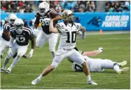  ?? AP PHOTO BY CHUCK BURTON ?? Wake Forest’s John Wolford (10) looks to pass against Texas A&M during the second half of the Belk Bowl Friday in Charlotte, N.C.