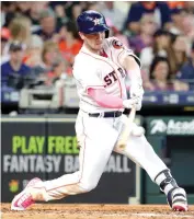  ?? Michael Wyke/Associated Press ?? ■ Houston Astros' Alex Bregman connects for a double during the seventh inning of a baseball game against the Texas Rangers on Sunday in Houston.