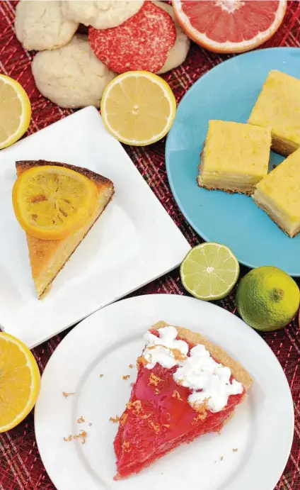  ?? Paul Stephen / Staff ?? We’re celebratin­g Texas’ citrus season in four desserts. Clockwise from left: Orange Syrup Cake with Candied Oranges, Lemon Sugar Cookies, Leftover Citrus Bars and Rio Star Grapefruit Pie.