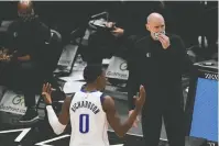  ?? The Associated Press ?? Dallas Mavericks head coach Rick Carlisle and Josh Richardson (0) argue with referees after Richardson was called for a foul during the second half of Sunday’s game against the Chicago Bulls in Chicago.