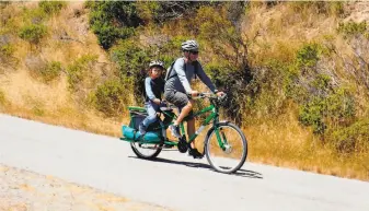  ?? Tom Stienstra / The Chronicle ?? Father and son bike the 5-mile Perimeter Road at Angel Island State Park, the most popular bike trail in the Bay Area. When the last ferry departs, it feels as if the whole island is yours.