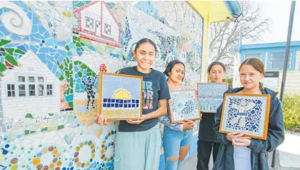  ?? Photos / Warren Buckland ?? Merena Tahat-Timas, Anika Tapiata-Harmer, Horiana Tahau and Georgia Epere with their mosaics in front of the mosaic commemorat­ing 100 years of Waima¯ rama School.