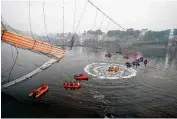  ?? AJIT SOLANKI/AP ?? Search and rescue work continues Monday after a cable suspension bridge collapsed in Morbi in the western state Gujarat, India Sunday evening.