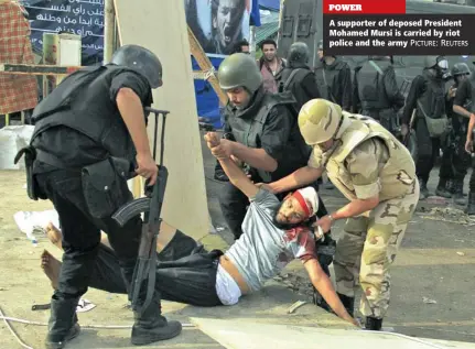  ?? PICTURE: REUTERS ?? POWER A supporter of deposed President Mohamed Mursi is carried by riot police and the army