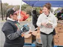  ?? ?? Roby’s mother, Danielle, right, said the giveaway reminded her of how food pantries helped her feed her three sons.