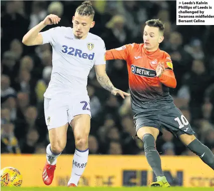  ??  ?? &gt; Leeds’s Kalvin Phillips of Leeds is challenged by Swansea midfielder Bersant Celina