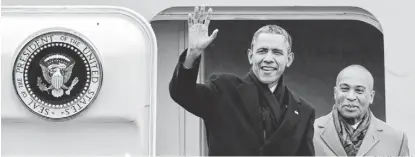  ?? CHARLES KRUPA, AP ?? President Obama waves as he is followed by Massachuse­tts Gov. Deval Patrick upon his arrival at Boston’s Logan Airport last week. Obama traveled to Boston to attend a pair of Democratic fundraiser­s.