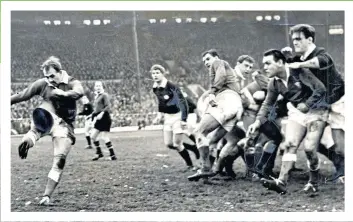  ??  ?? Booted out: Welsh team captain Clive Rowlands directs one of his innumerabl­e kicks to touch in his side’s 6-0 win over Scotland in 1963